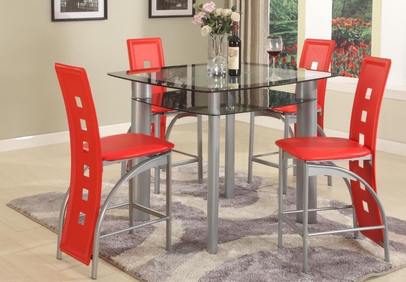 A dining room with a glass table and red chairs