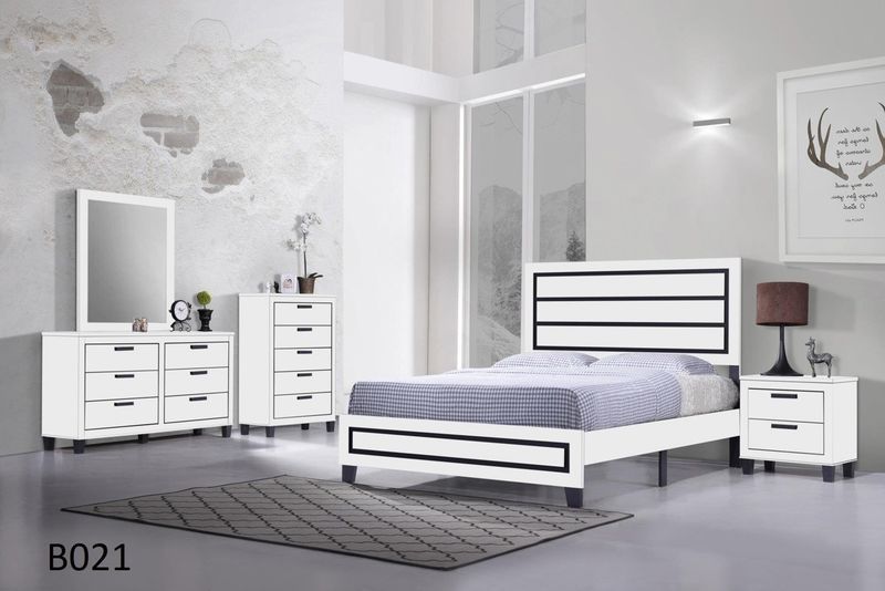 A bedroom with a bed dresser mirror and nightstand