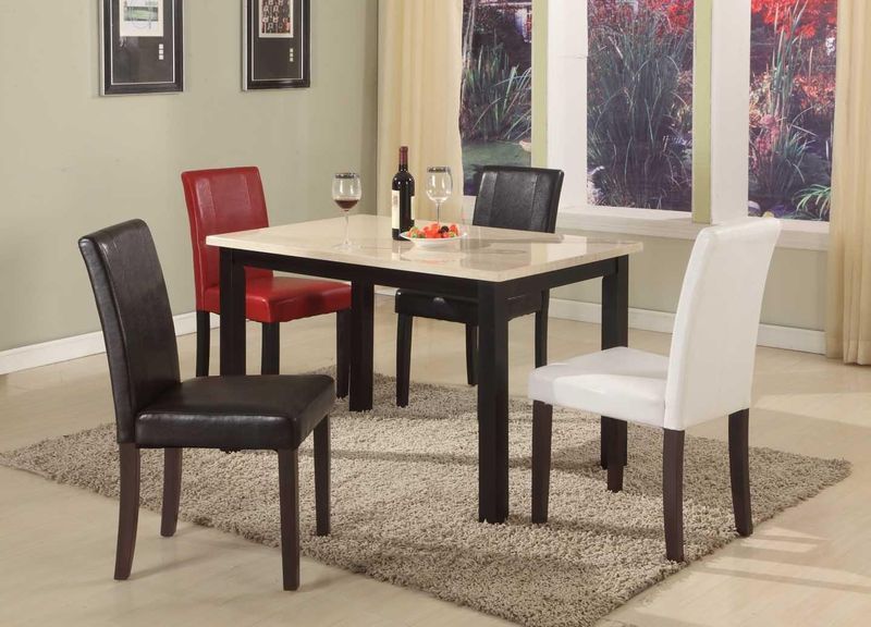 A dining room table with four chairs and a bottle of wine on it