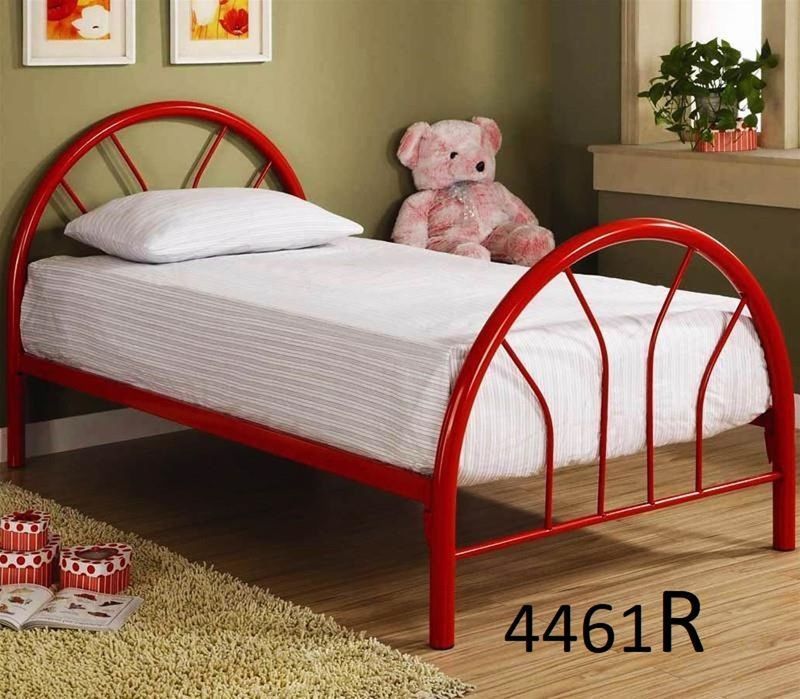 A red bed with white sheets and a teddy bear on it