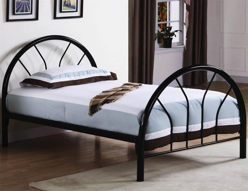 A black metal bed frame with a white mattress and pillows
