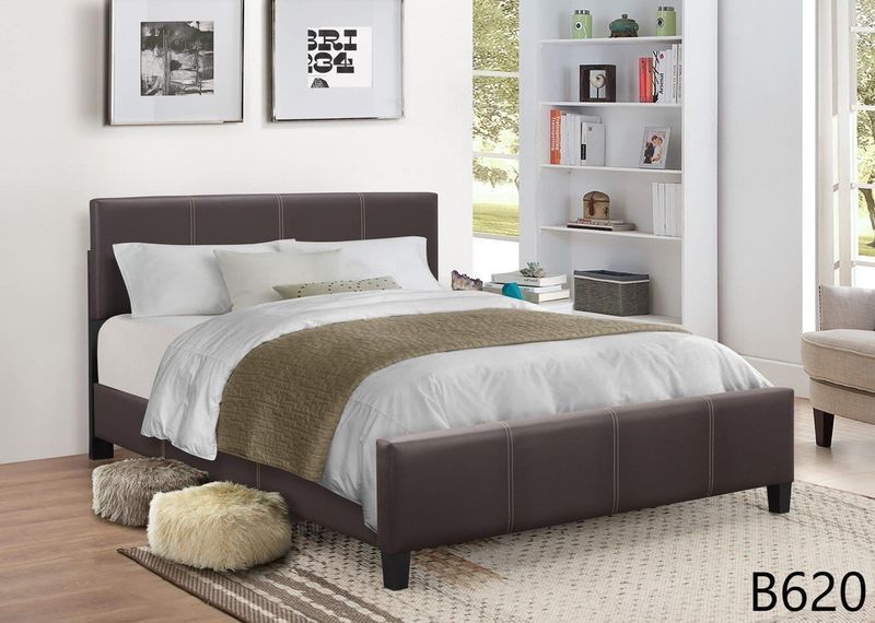 A bed with white sheets and a brown headboard is in a bedroom.