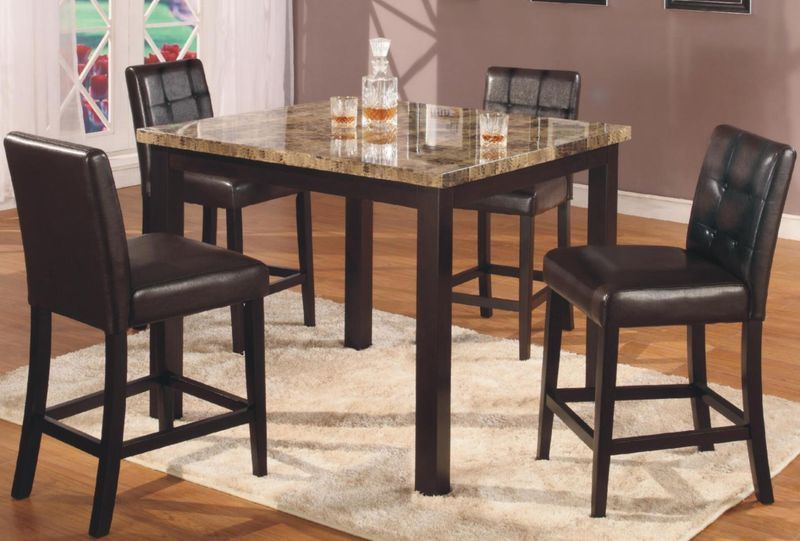 A table with a marble top and four chairs