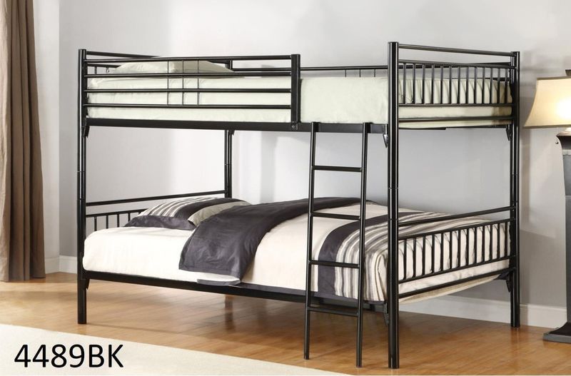 A black bunk bed with a ladder in a bedroom.