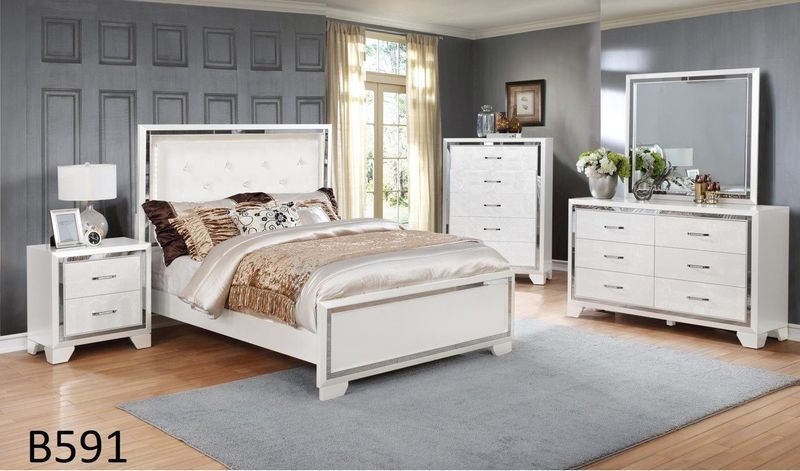 A bedroom with a bed dresser mirror and nightstand