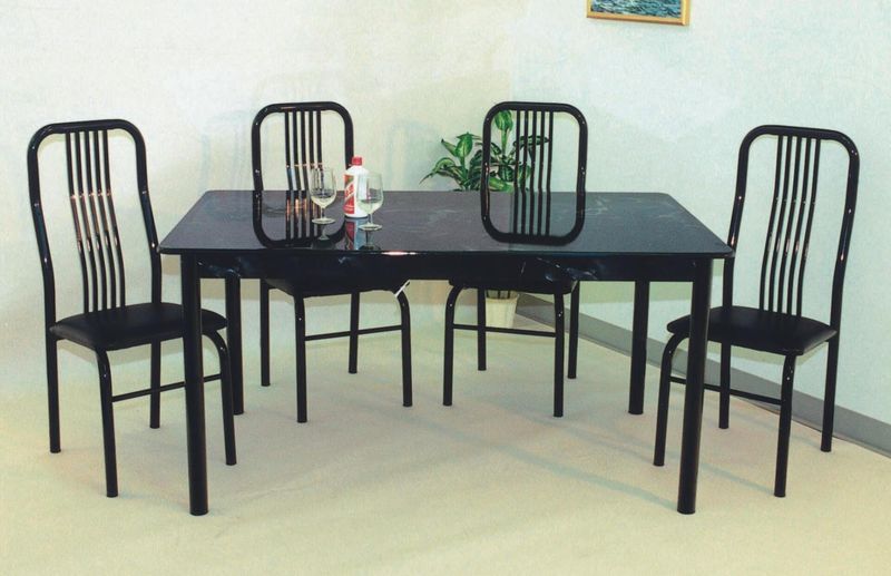 A black dining table with four black chairs