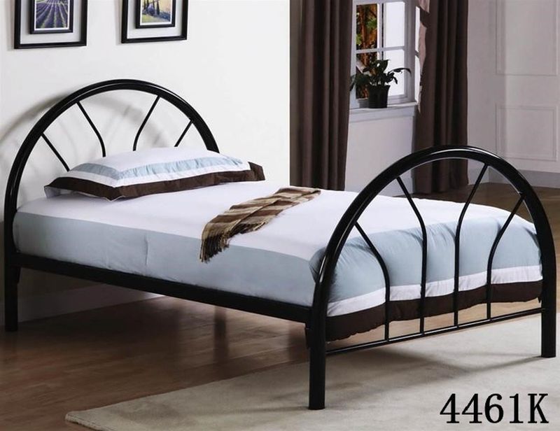 A black metal bed frame with a white mattress