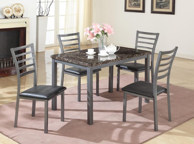 A marble dining table with four chairs in a living room