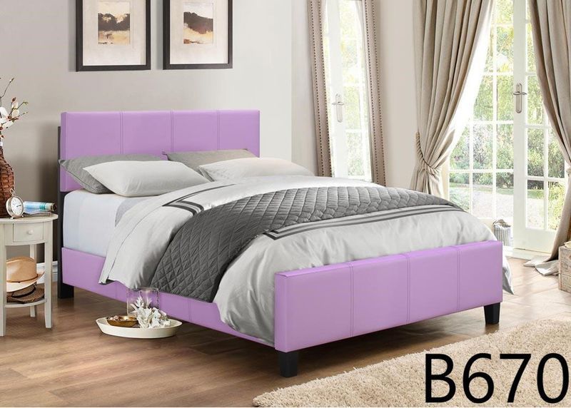 A bedroom with a purple bed and a purple headboard.