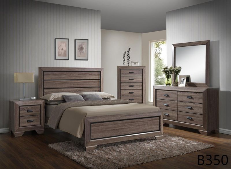 A bedroom with a bed , dresser , nightstand , mirror and rug.