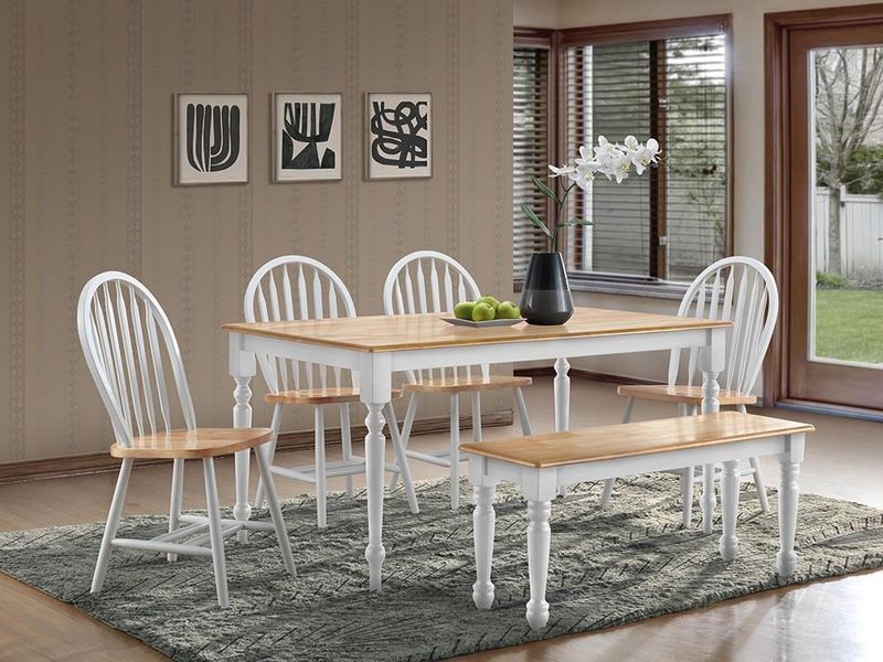 A dining room with a table and chairs and a bench
