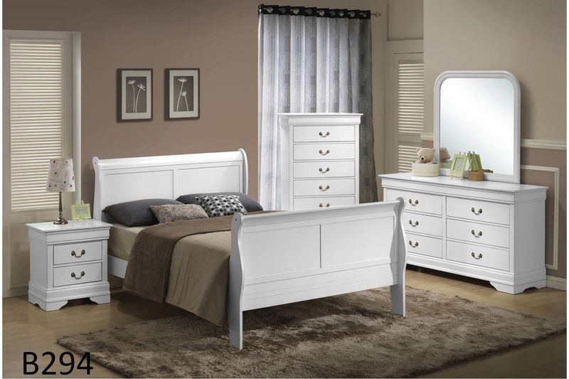 A bedroom with a white sleigh bed , dresser , nightstand and mirror.