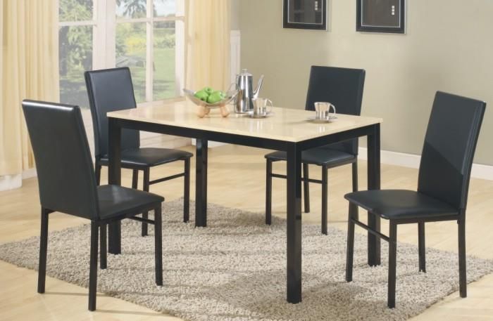 A dining room table with black chairs and a rug