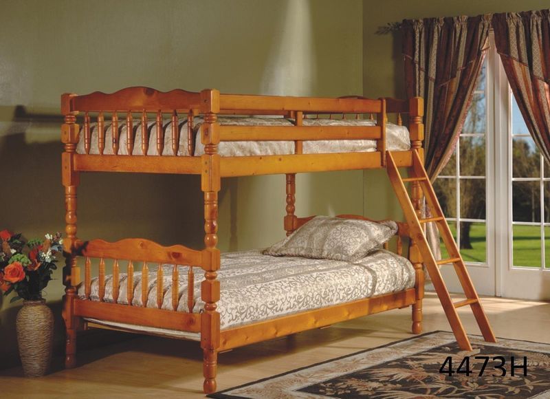 A wooden bunk bed with a ladder in a bedroom