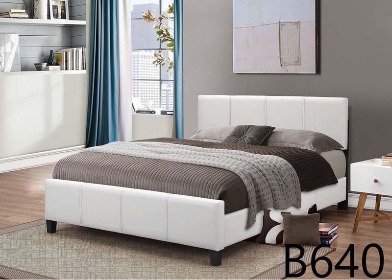 A bedroom with a bed and a nightstand with the number b640 on it