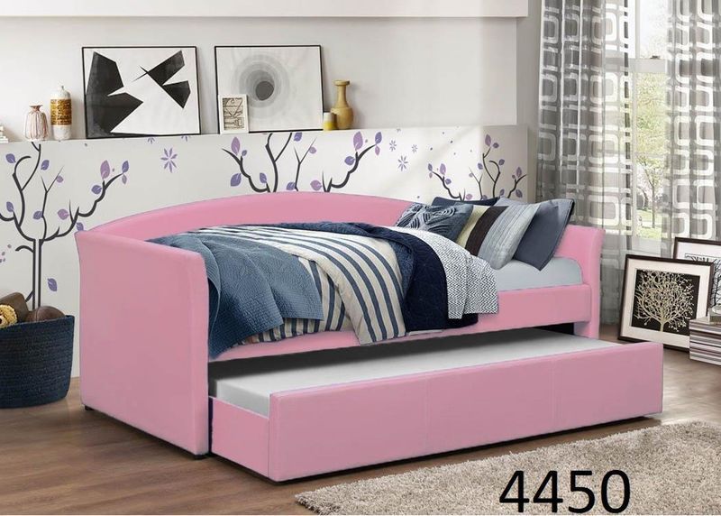 A pink day bed with a pull out bed underneath it in a bedroom.