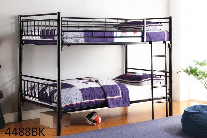 A black bunk bed with purple sheets and pillows