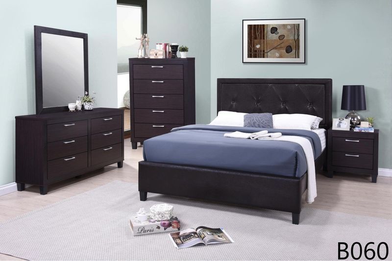 A bedroom with a bed dresser mirror and nightstand