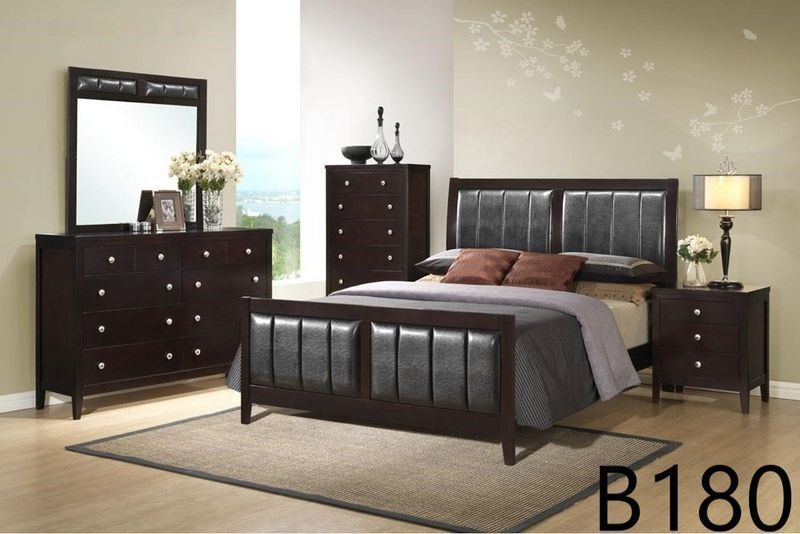 A bedroom with a bed dresser and nightstand with the number b180 on the floor