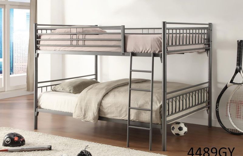 A bunk bed with a ladder is in a room next to a bicycle.