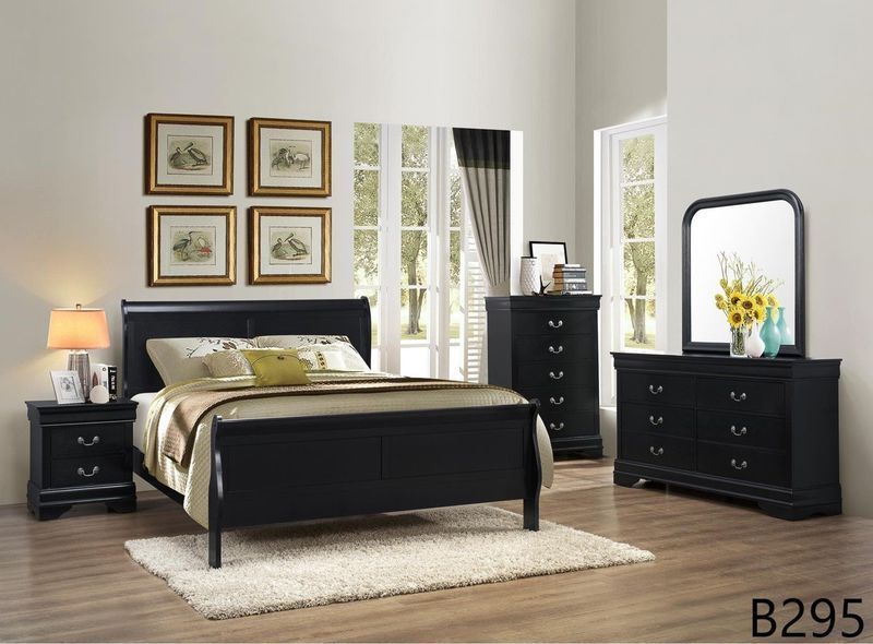 A bedroom with a bed dresser mirror and nightstand