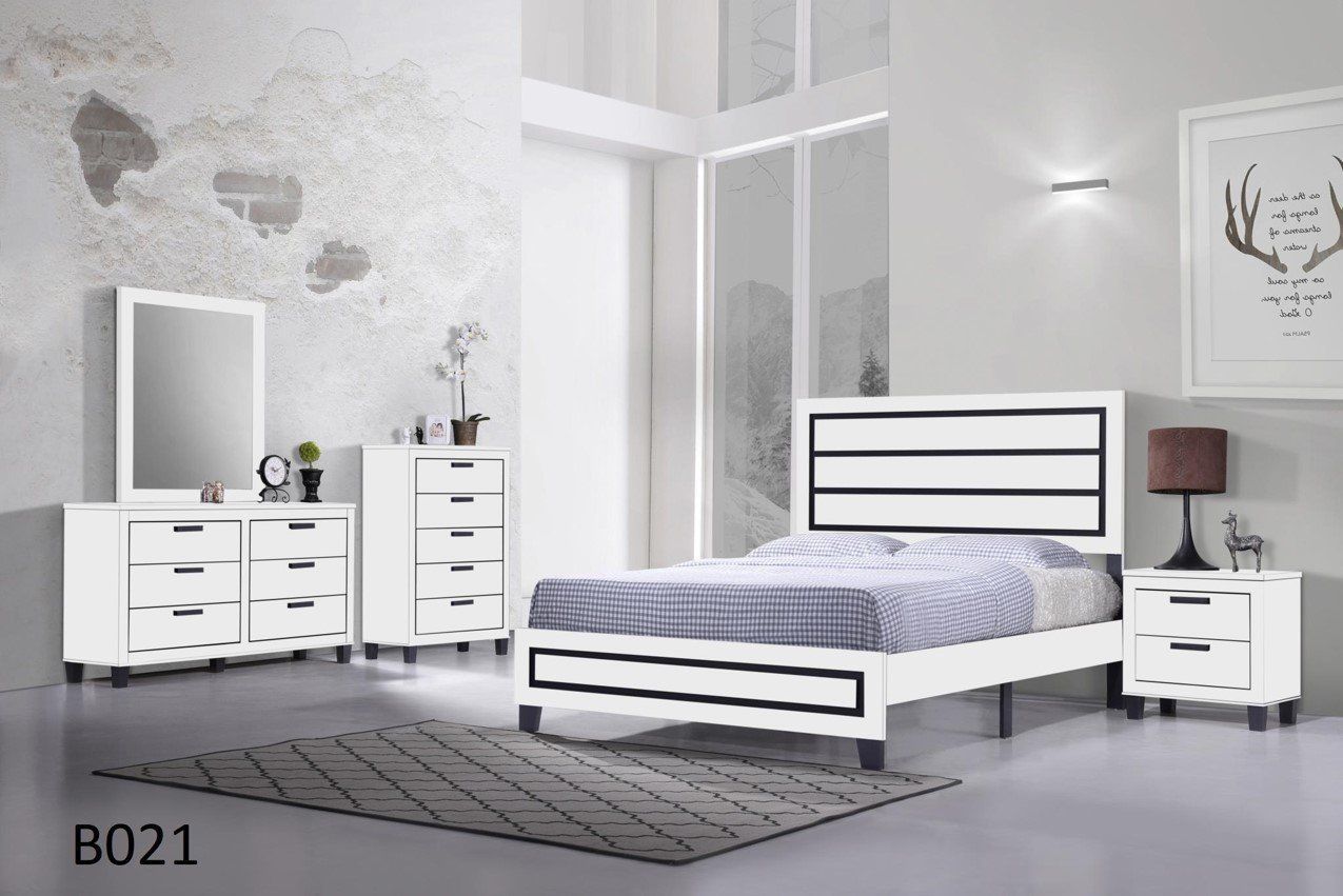 A bedroom with a bed , dresser , nightstand , mirror and rug.