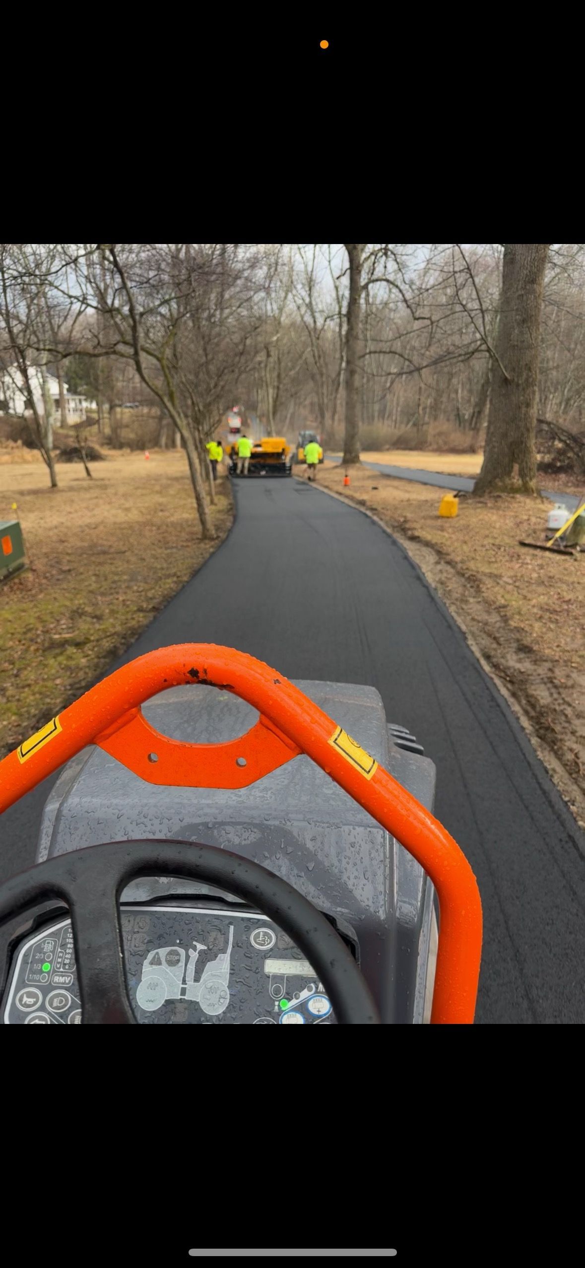 A person is driving a tractor down a road.