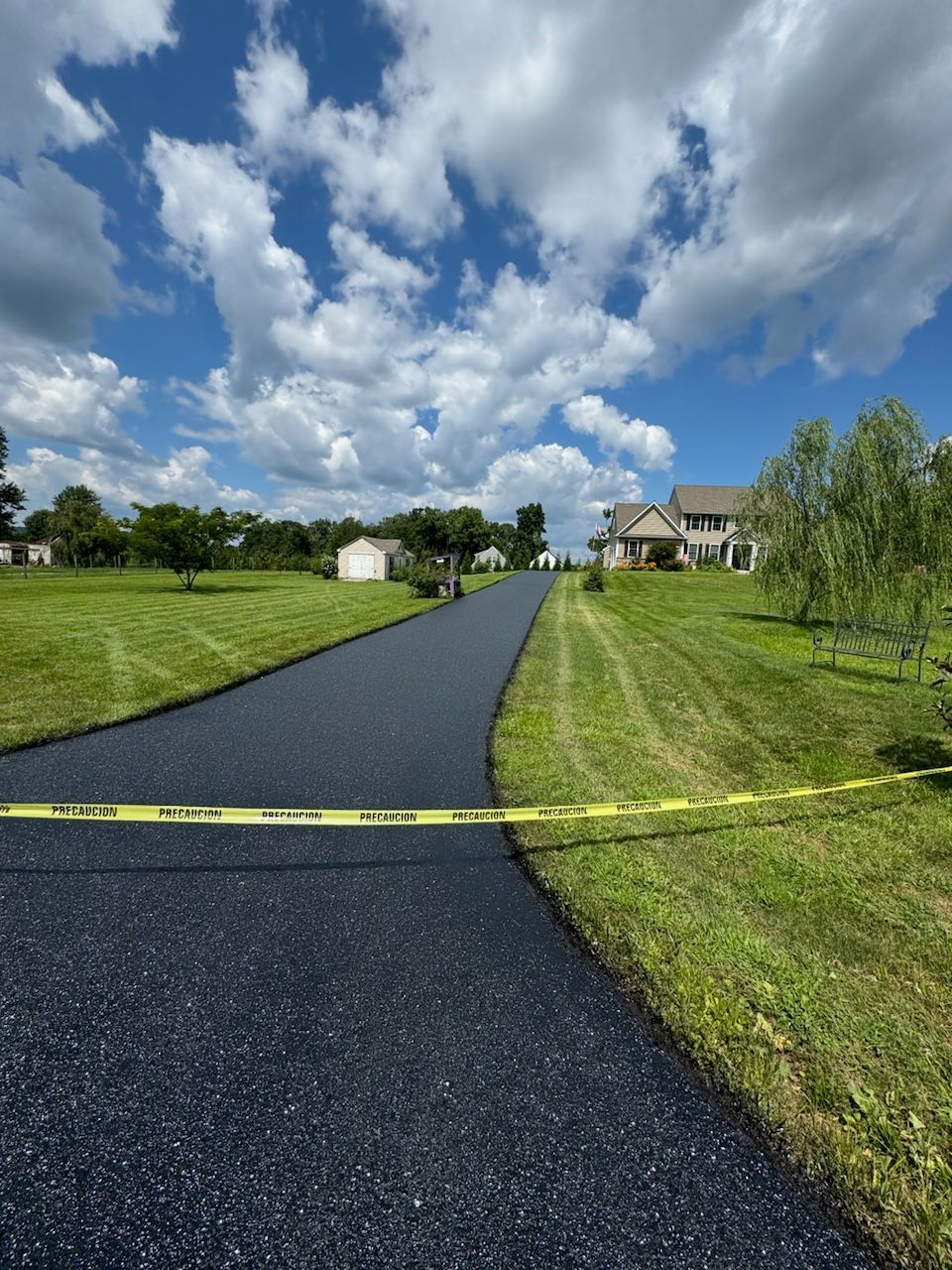 A driveway leading to a house in a residential area
