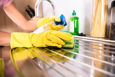 Residential Cleaning Services — Hand Cleaning Stainless Steel Sink in Jensen Beach, FL