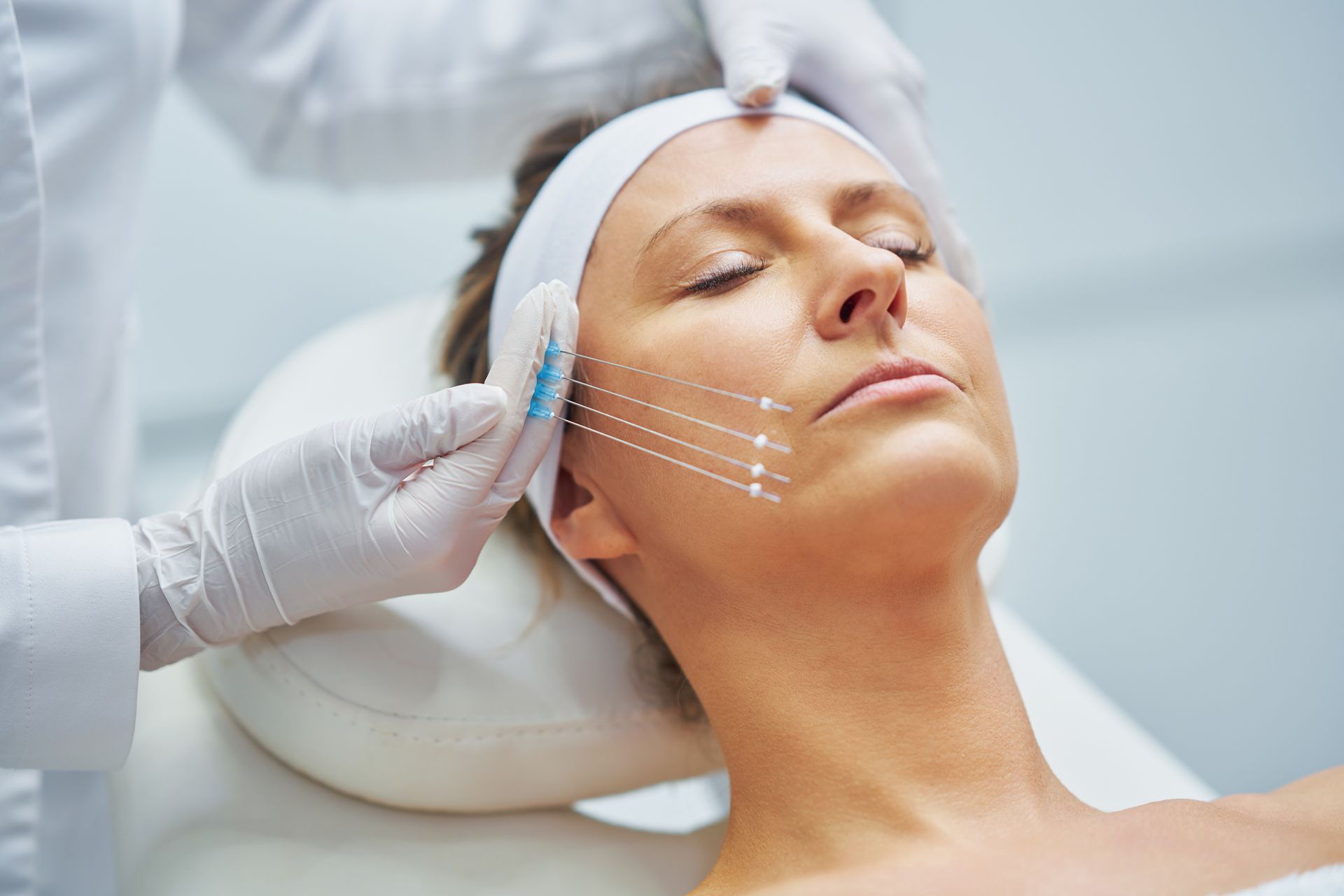 A woman is getting a facial treatment at a beauty salon.