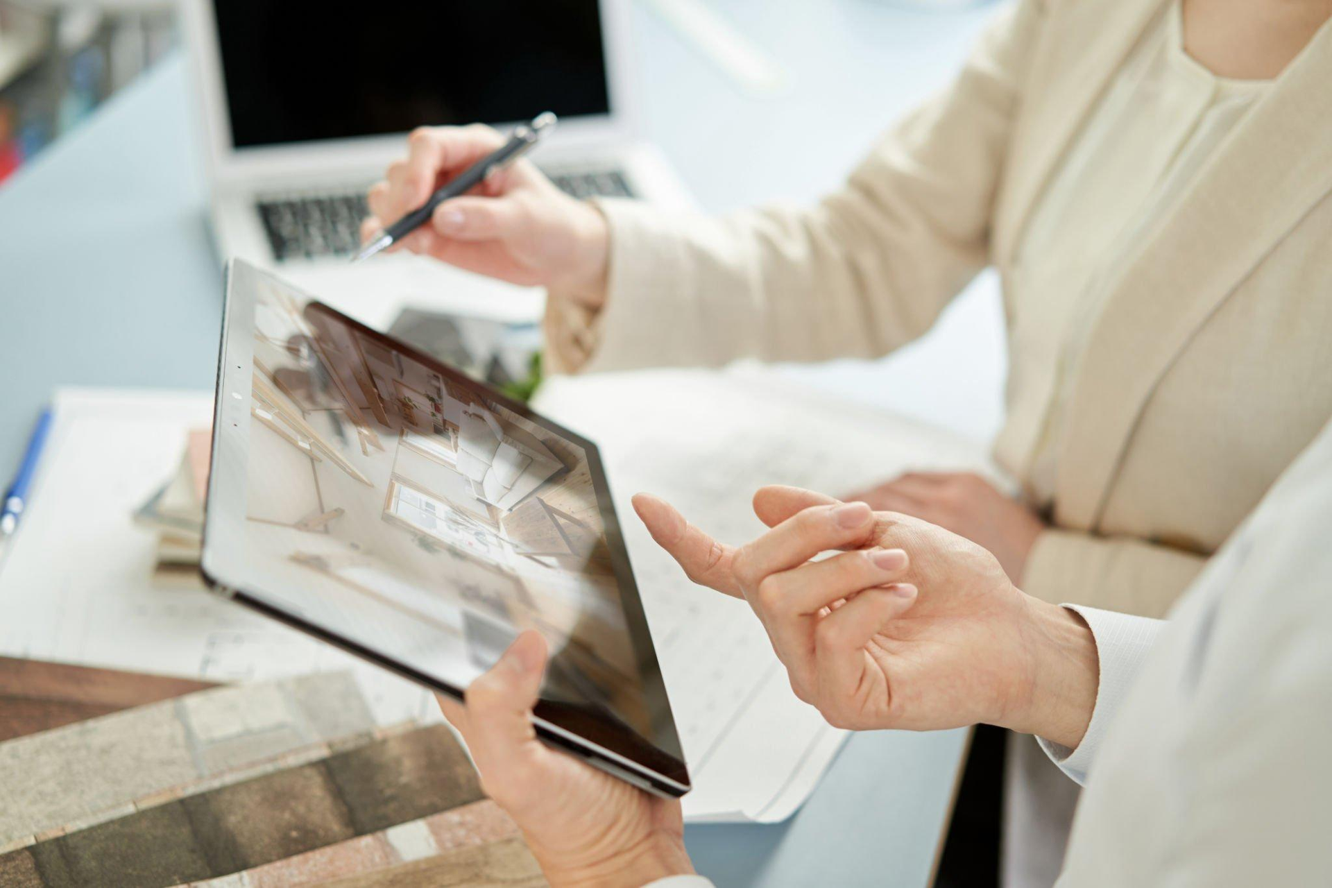 A man and a woman are looking at a tablet computer.