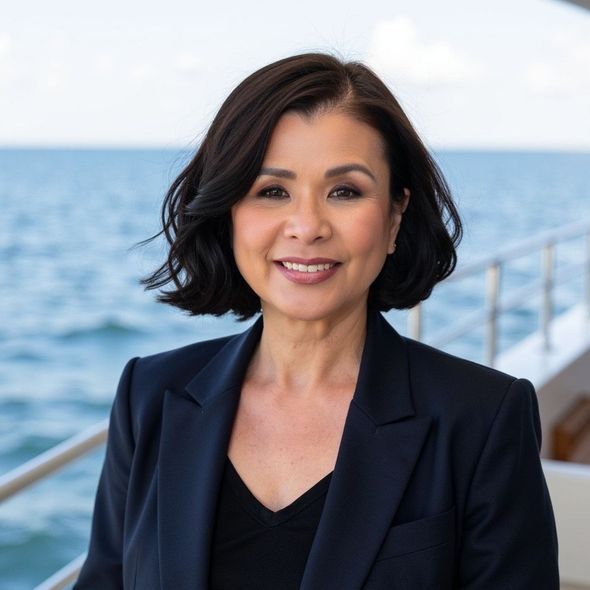A woman with dark hair is smiling for the camera