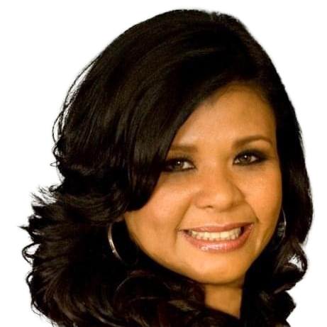 A woman with dark hair is smiling for the camera