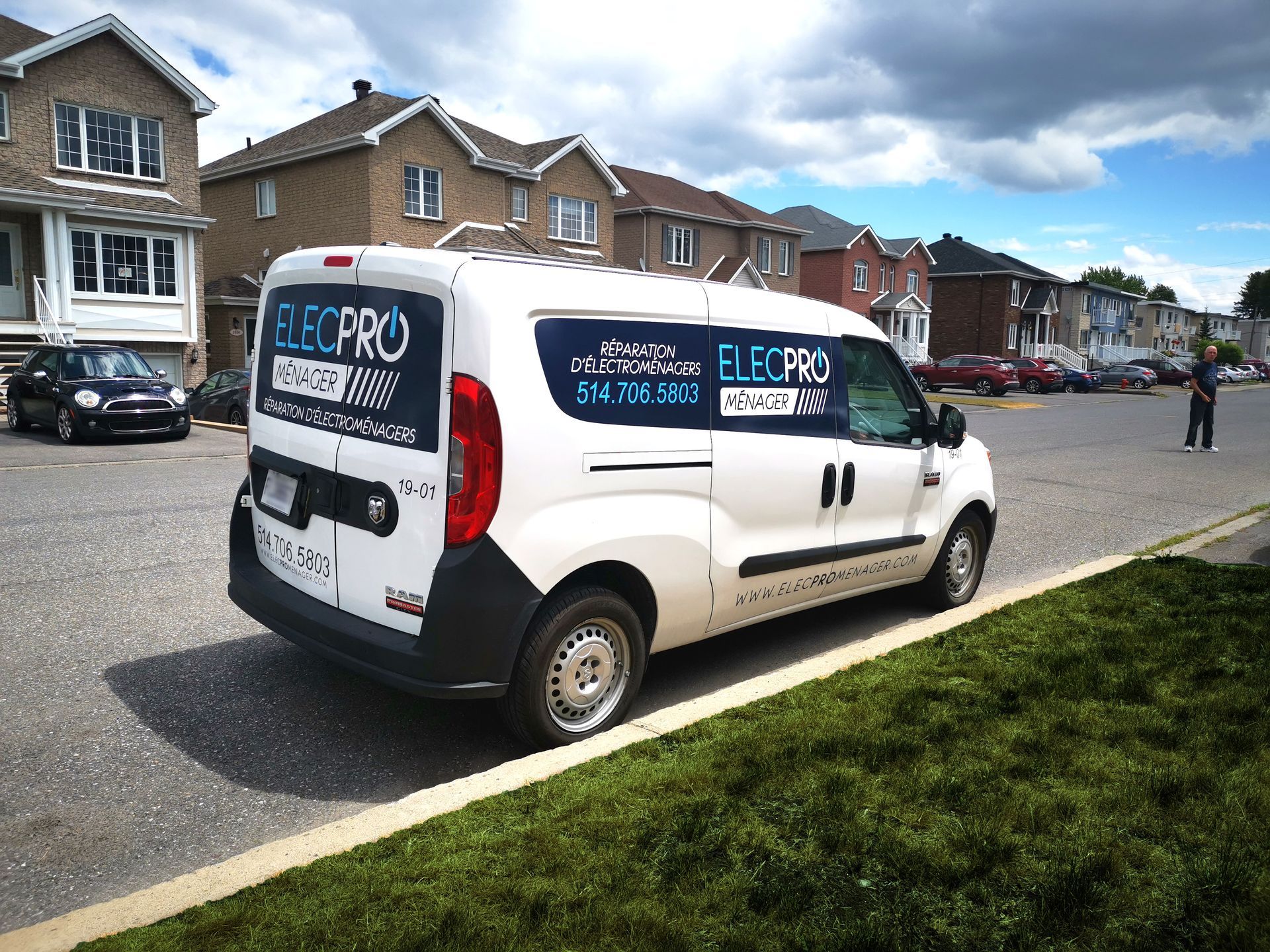 Une camionnette blanche est garée sur le bord de la route.