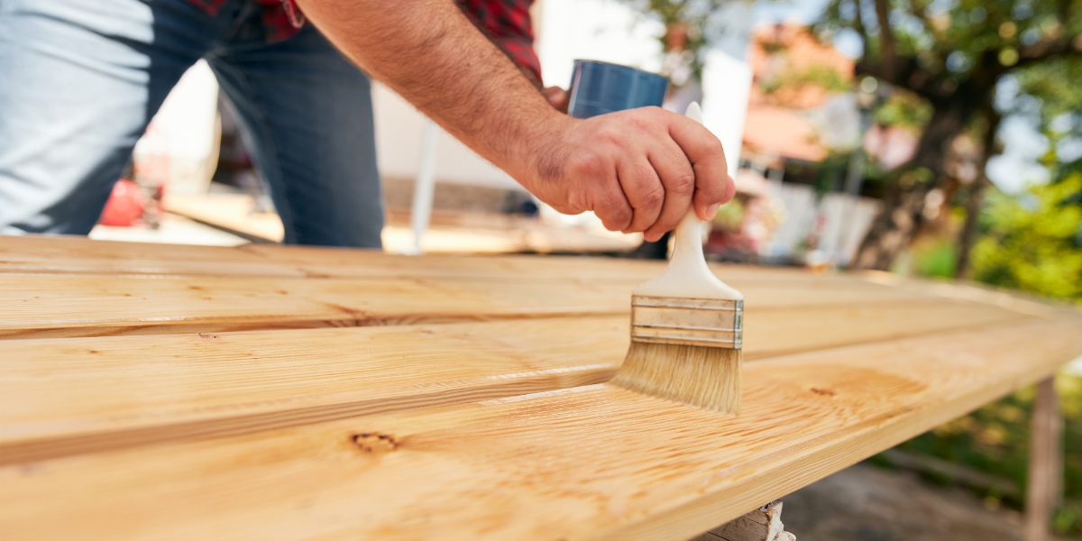 Contractor in Big Bear Lake painting a wood board