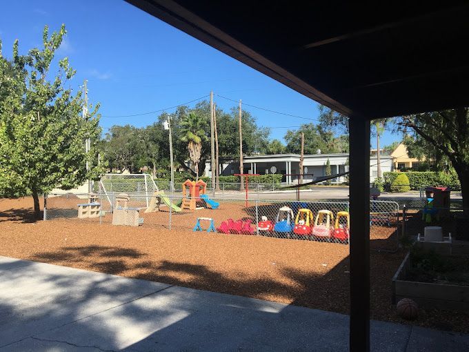 A view of a playground from a porch on a sunny day