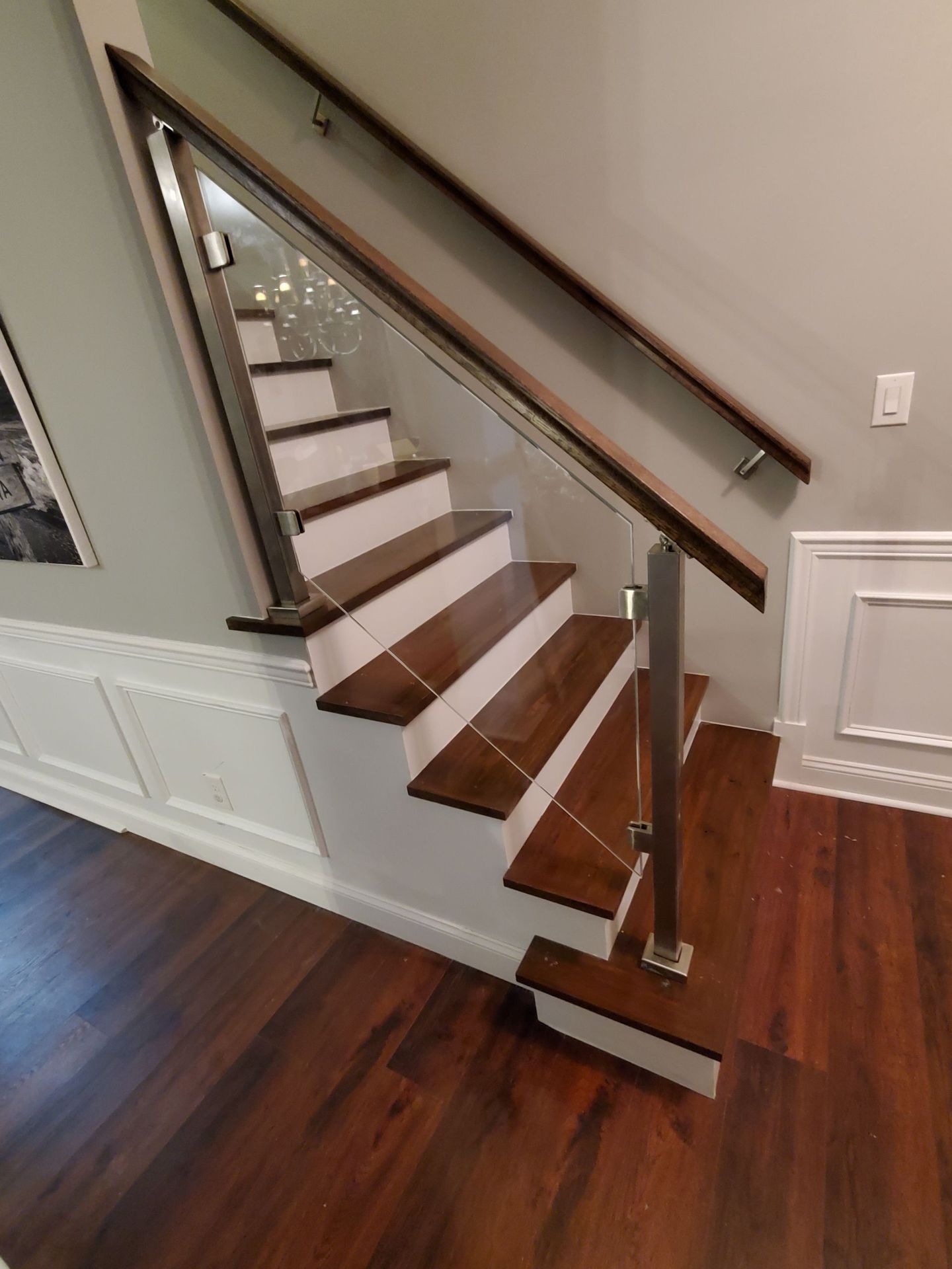 A staircase with wooden steps and a glass railing