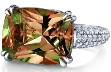 A ring with a brown and green stone on it