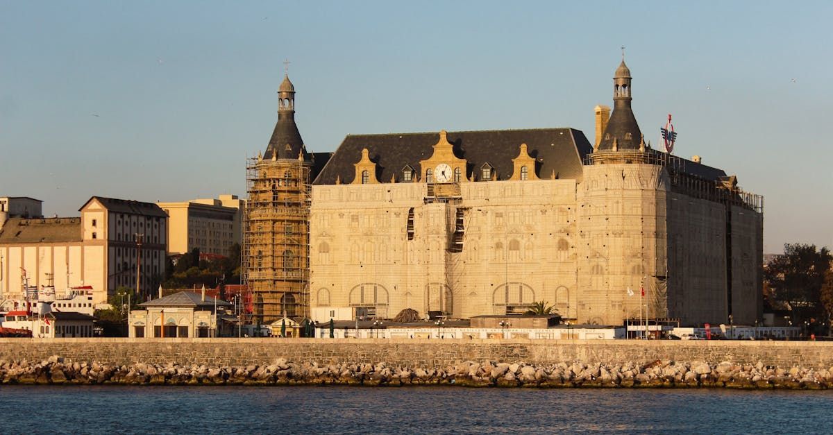 A man and a woman are riding a red atv on a dirt road.