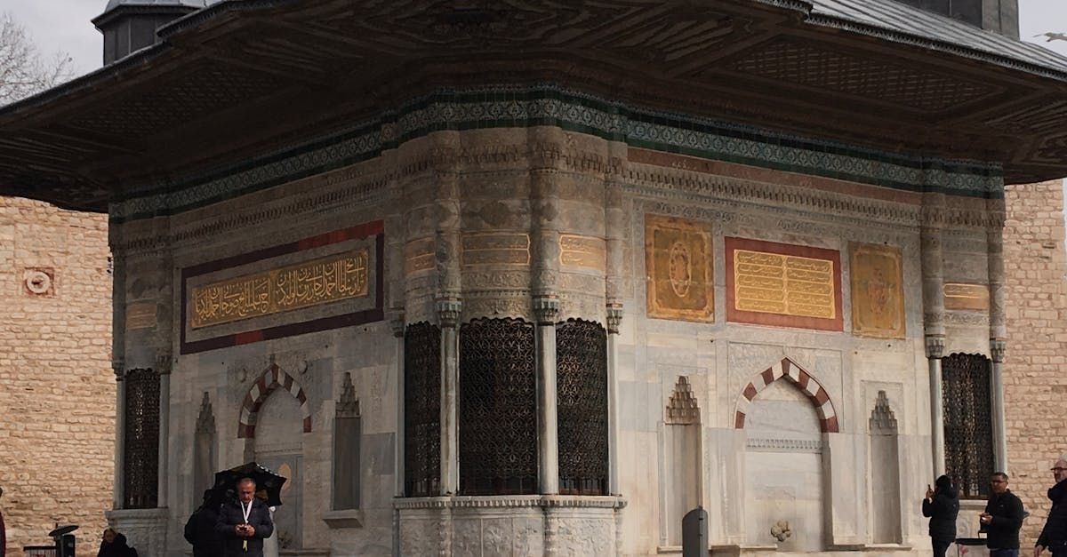A group of people are riding atvs down a dirt road.