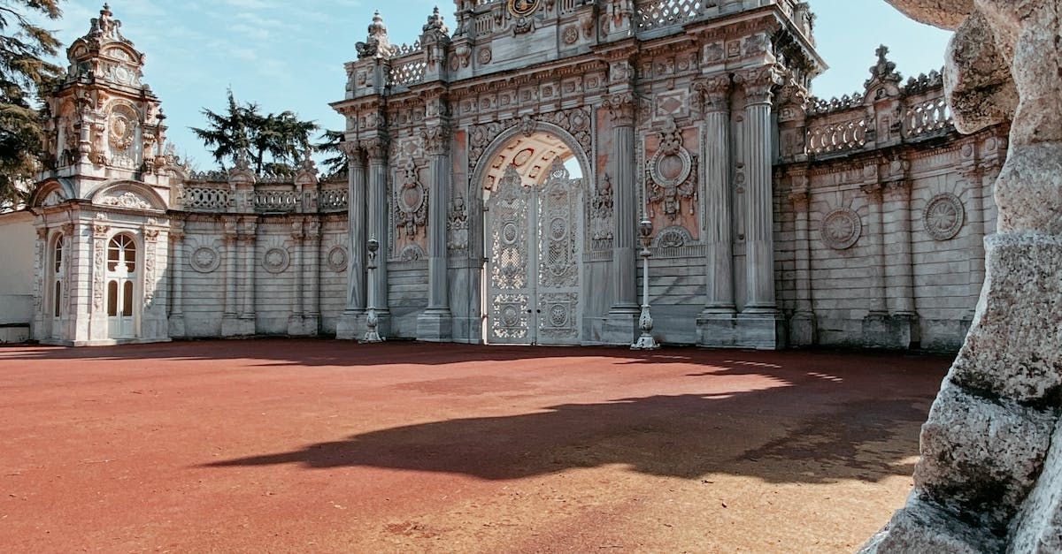 A man is riding an atv in the desert with mountains in the background.