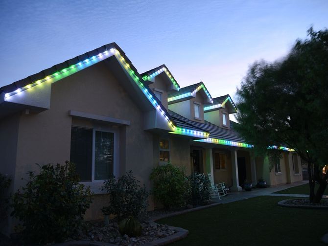 A house is decorated with christmas lights at night.