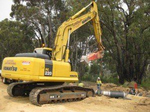An excavator with a worker on their front | Northam, WA | Lloyd’s Earthmoving