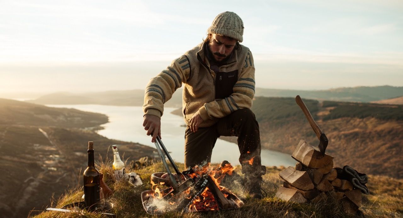 chef cooking on mountain with fire