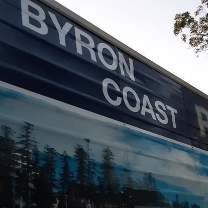 A Close Up Of Sign Writing On A Truck— Byron Coast Removals In Main Arm, NSW