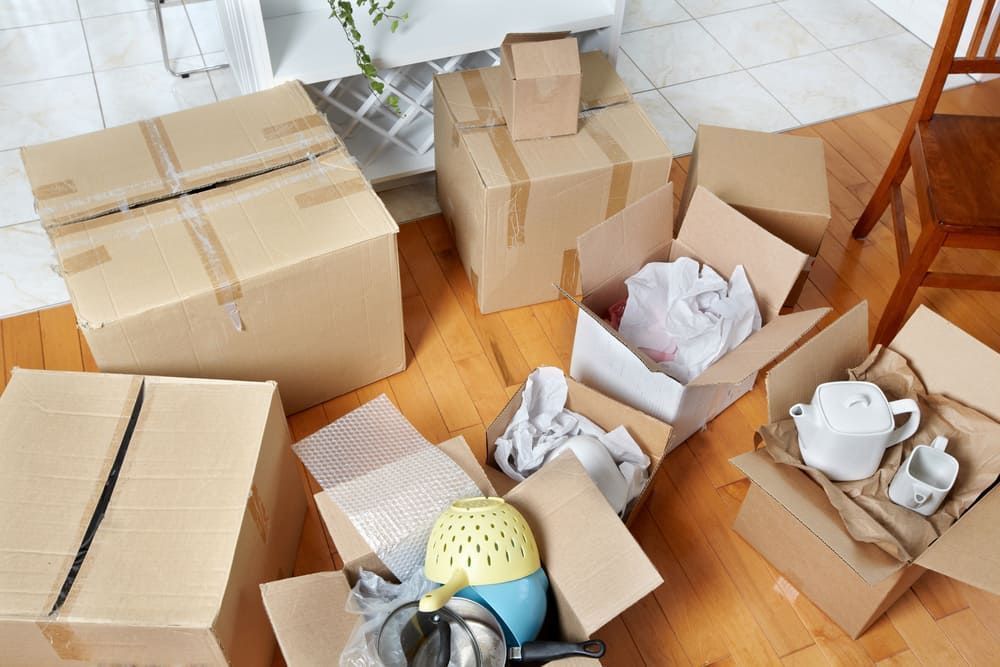 A Bunch Of Cardboard Boxes Are Sitting On The Floor In A Living Room — Byron Coast Removals In Main Arm, NSW