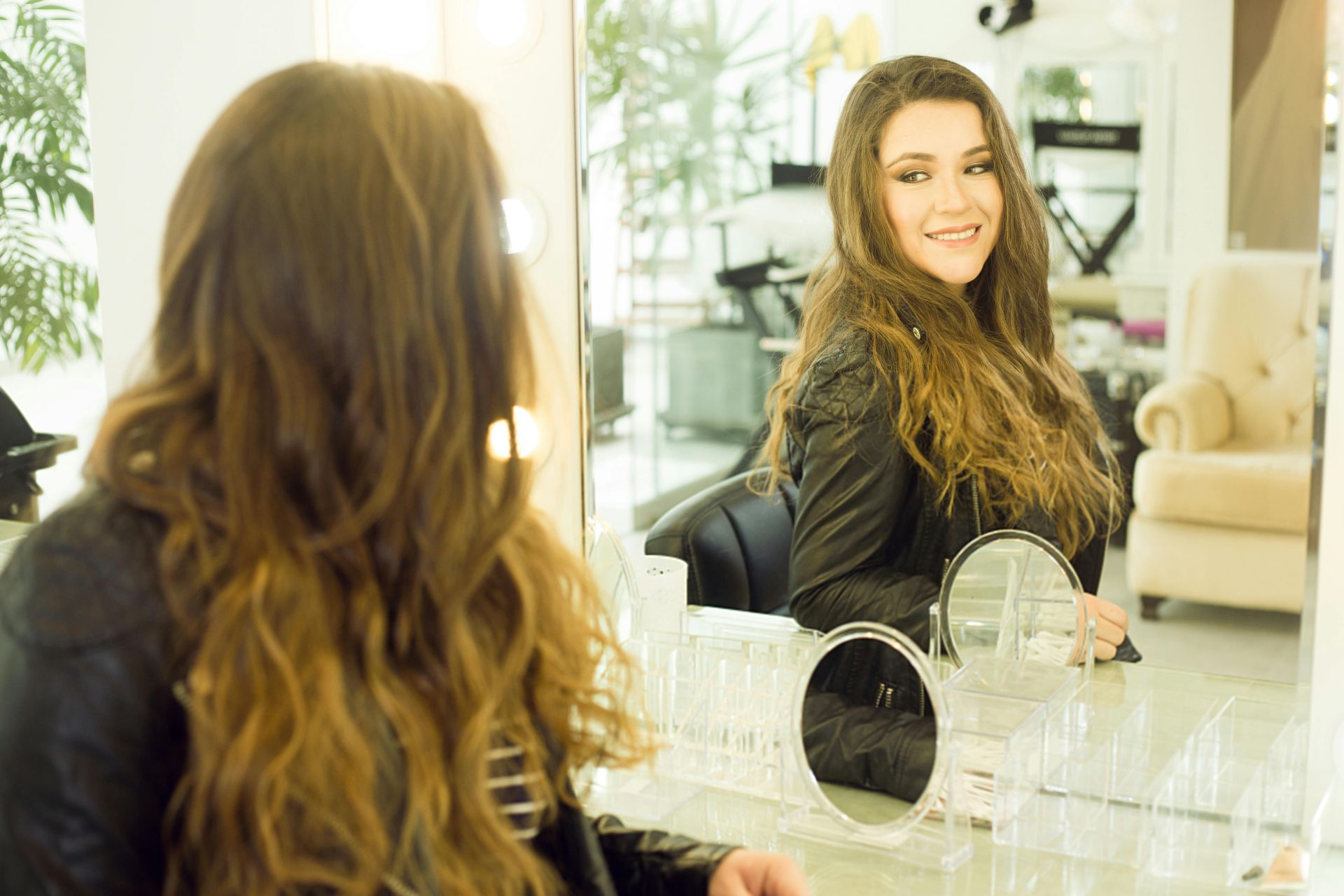 Happy stylist representing strong culture and leadership that retain staff.