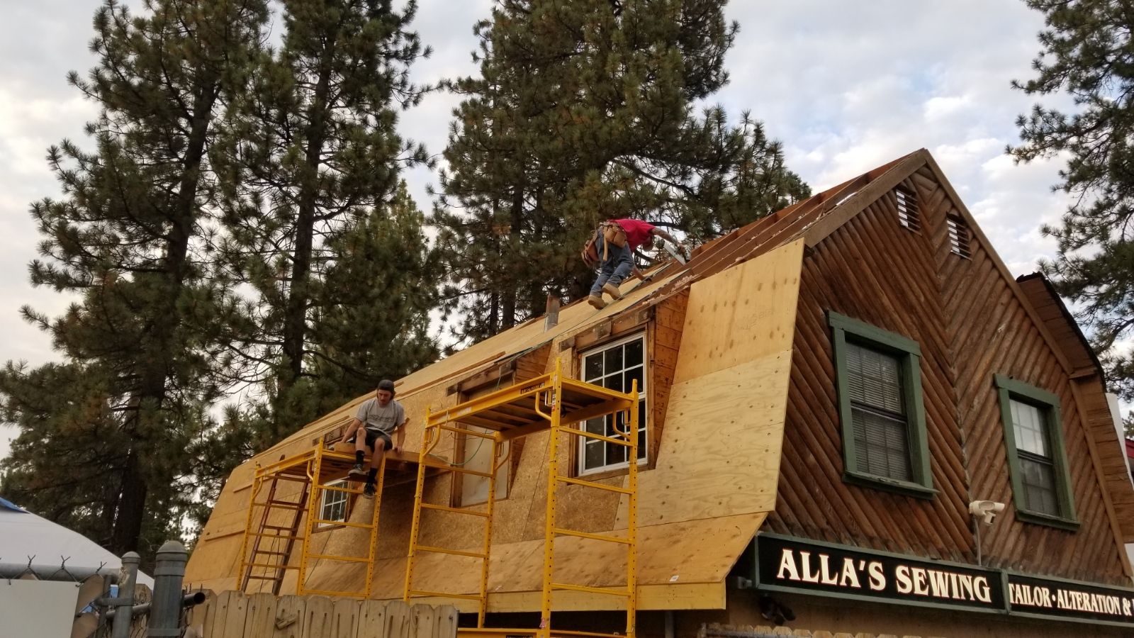 A group of people are working on the roof of a building.