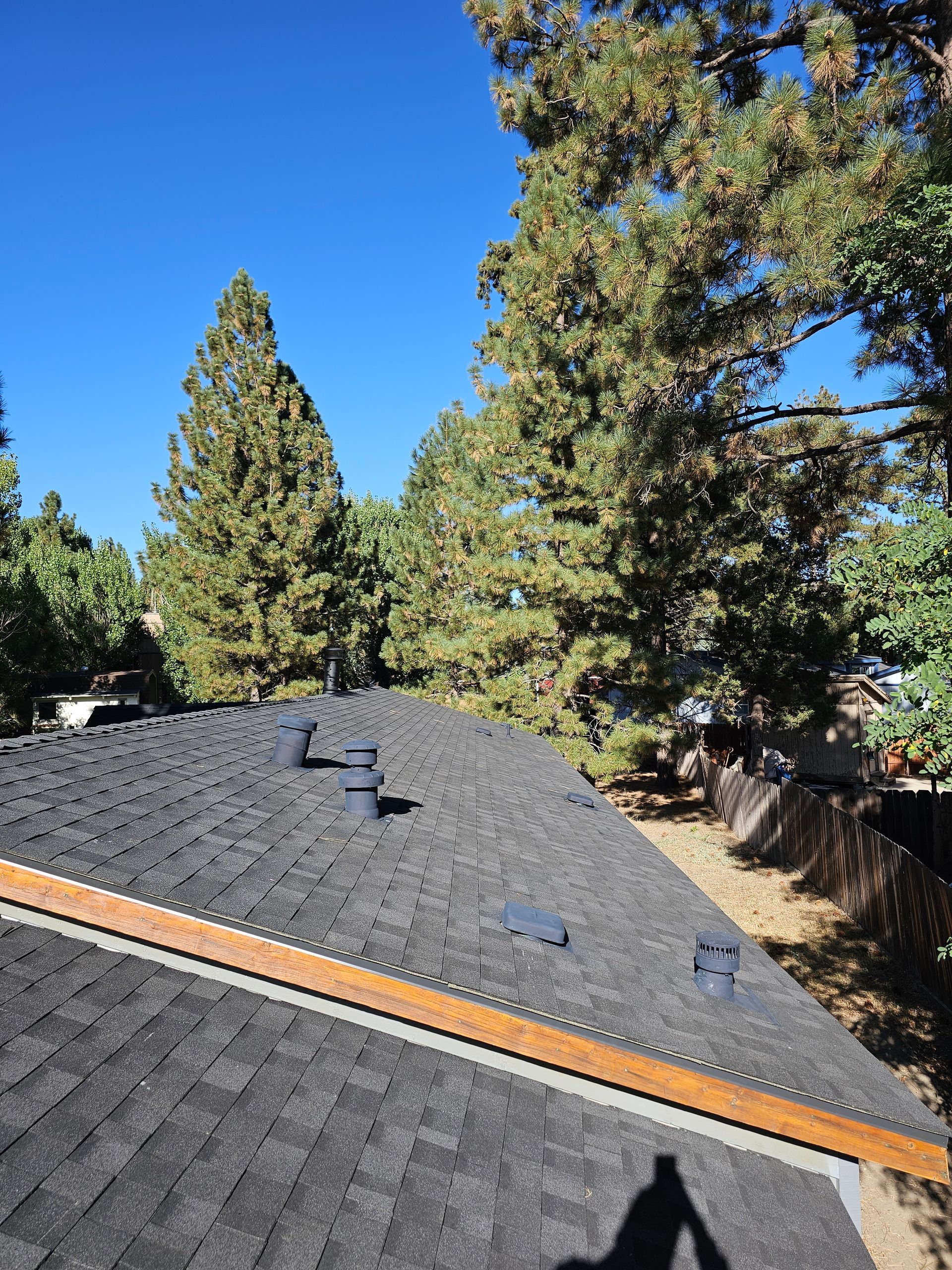 A roof with a shadow of a person on it