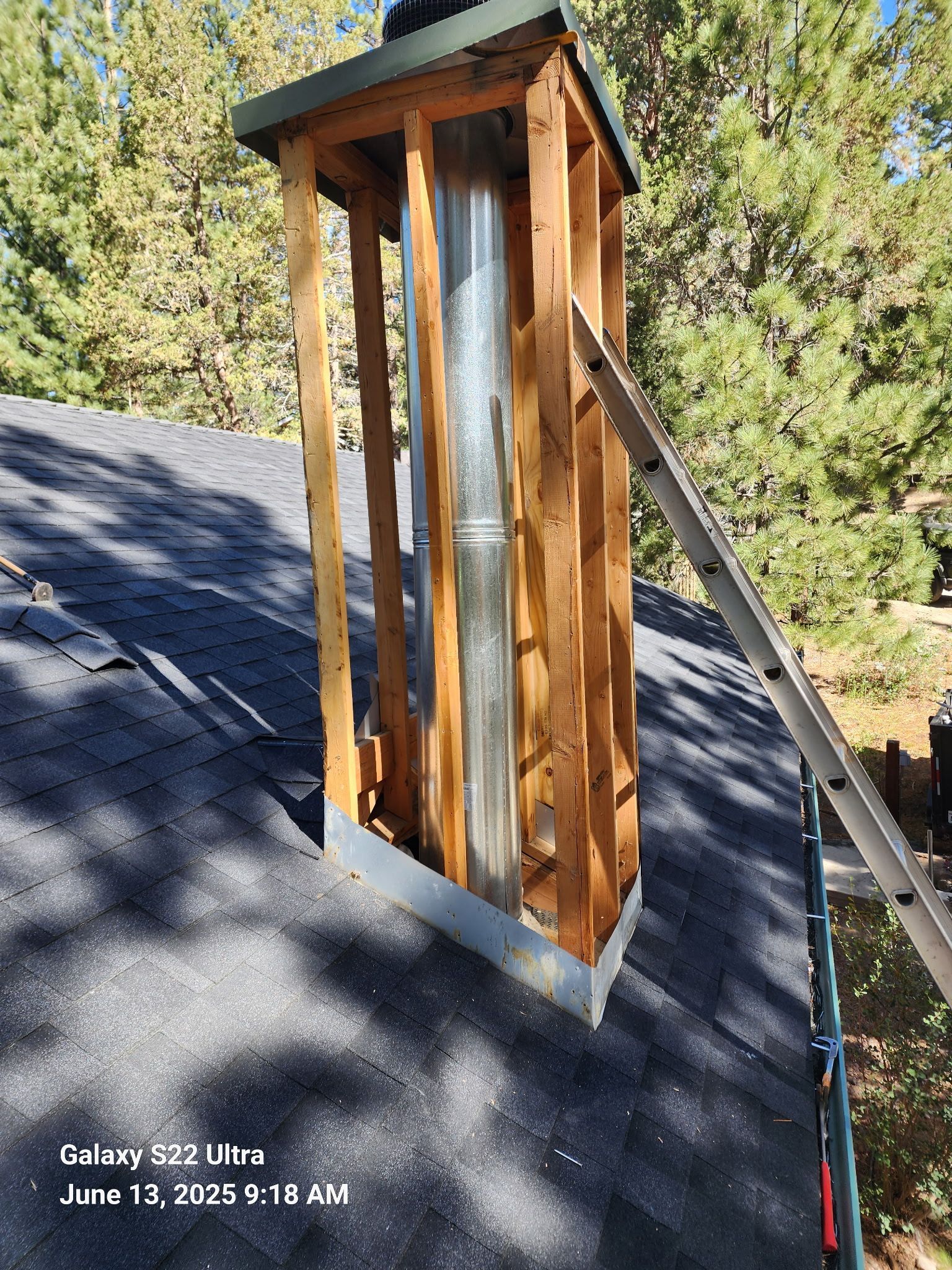 A chimney is being built on top of a roof.
